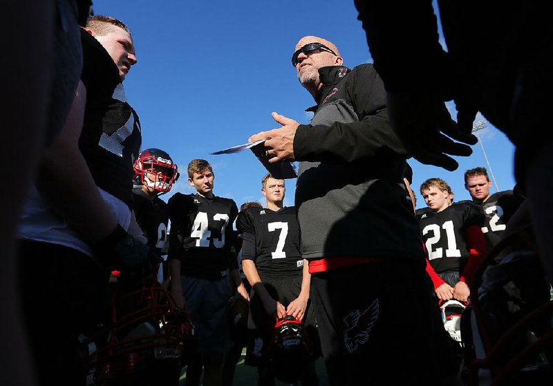 First-year Pea Ridge Coach Stephen Neal talks with his team during the Blackhawks’ practice at War Memorial Stadium in Little Rock on Tuesday. Pea Ridge will make its first appearance in a state title game Friday night at 7 p.m. when it faces Warren.