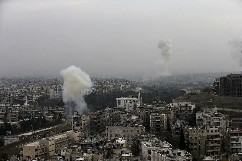 Smoke rises in east and west neighborhoods during a battle between forces loyal to Syrian President Bashar Assad and rebels Monday in Aleppo, Syria. Syrian forces gained further ground in Aleppo on Tuesday.