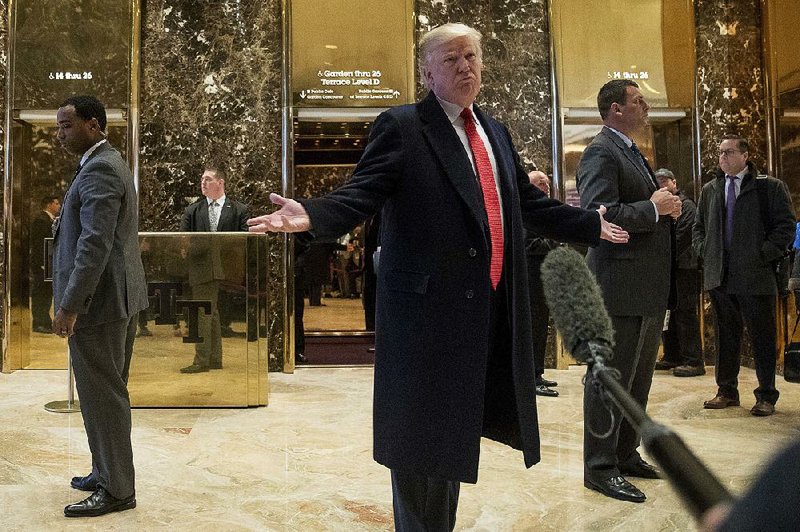 President-elect Donald Trump speaks to reporters Tuesday in the lobby of Trump Tower in New York before heading to North Carolina to salute his supporters there.