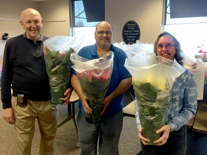 Photo submitted Siloam Springs Kiwanis members Wendell Skelton, Mike Velo and Dolores Deuel distributed the poinsettia plants from their annual fundraiser. Proceeds are used to help children and youth in Siloam Springs.