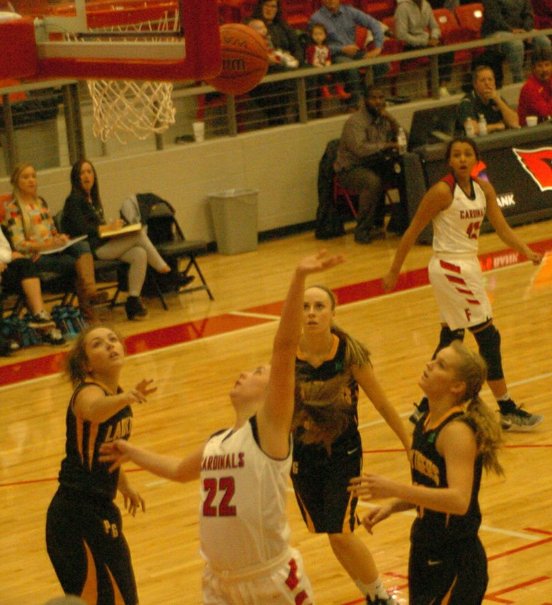 MARK HUMPHREY ENTERPRISE-LEADER Farmington freshman Makenna Vanzant scores a left-handed layup during a Nov. 28 win over rival Prairie Grove. Vanzant led the Lady Cardinals with 20 points in her varsity debut in the 57-50 victory.