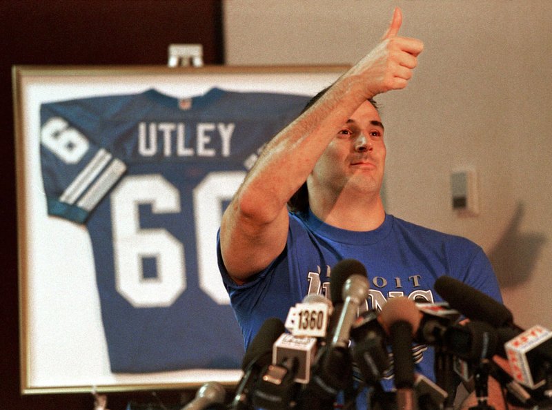  In this Feb. 15, 1999 file photo, former Detroit Lions guard and Washington State lineman Mike Utley gives the thumbs-up after successfully walking from his wheelchair at a Phoenix hotel. 