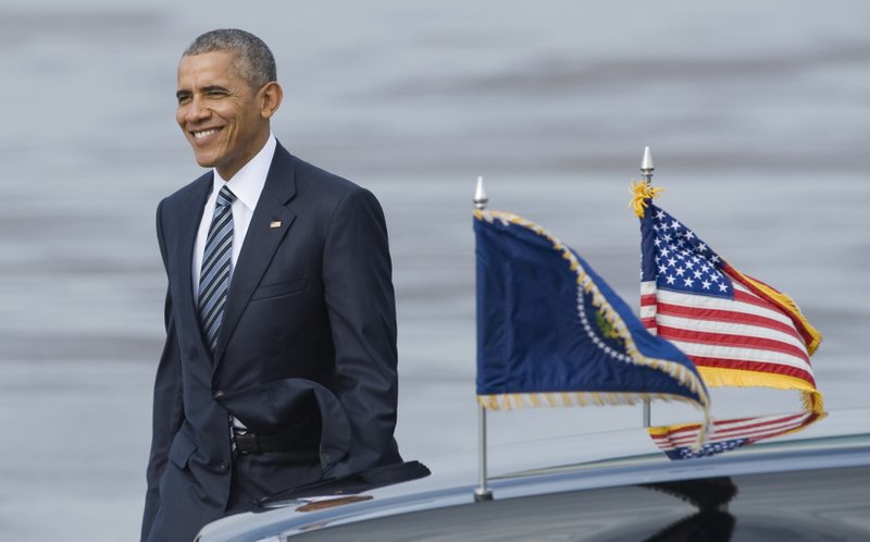 President Obama walks across the tarmac to greet a crowd of well-wishers after arriving at Tampa International Airport aboard Air Force One Tuesday, Dec. 6, 2016, in Tampa, Fla. Obama is in Tampa to visit Central Command at MacDill Air Force Base. (AP Photo/Steve Nesius)