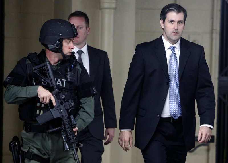 In this Monday, Dec. 5, 2016 file photo, Michael Slager, at right, walks from the Charleston County Courthouse under the protection from the Charleston County Sheriff's Department after a mistrial was declared for his trial in Charleston, S.C.