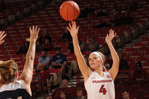 Keiryn Swenson (4) of Arkansas takes a 3-point shot over Tori Schickel of Butler Wednesday, Dec. 7, 2016, during the first half of play in Bud Walton Arena in Fayetteville.