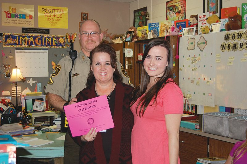 Southside Elementary School teacher Tina Dunn, center, was recently surprised by her daughter Katelyn Edgin, right, and her husband, Josh Dunn, after Tina was awarded the Teacher Impact Celebration Award on Dec. 2. 
