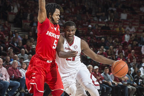 Manuale Watkins (21) of Arkansas drives to the basket as Morris Dunnigan (5) of Houston defends Tuesday, Dec. 6, 2016 at Bud Walton Arena in Fayetteville. The Razorbacks won 84-72.