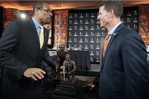Clemson Defensive Coordinator Brent Venables, winner of the 2016 Broyles award, and Mark May, ABC/ESPN analyst, talk after the 2016 Broyles Awards ceremony at the Marriott in Little Rock on Tuesday, Dec. 6, 2016.