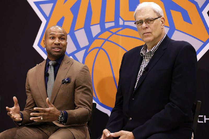 While New York Knicks president Phil Jackson, right, listens, Derek Fisher speaks during a news conference in Tarrytown, N.Y., Tuesday, June 10, 2014.