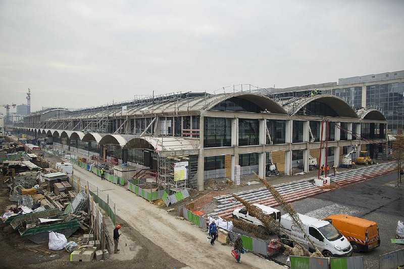 Building materials are stacked outside a former railway depot in Paris, where French billionaire Xavier Niel wants to create a huge technology park and space for startup businesses to be called Station F. 