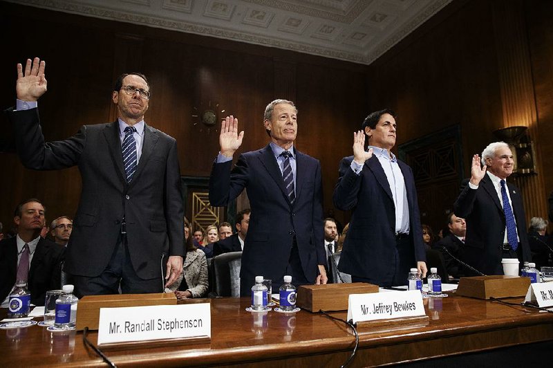 AT&T Chairman and CEO Randall Stephenson (from left), Time Warner Chairman and CEO Jeff Bewkes, AXS TV Chairman and Dallas Mavericks owner Mark Cuban and Public Knowledge Chairman and CEO Gene Kimmelan are sworn in on Capitol Hill on Wednesday before a hearing on the proposed merger of AT&T and Time Warner. 