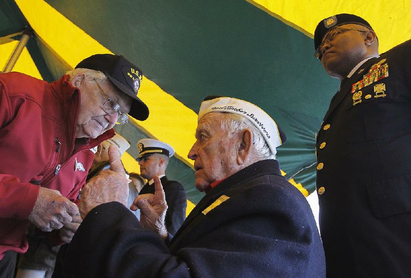 Pearl Harbor survivor Bill Chase (center) of Pearcy, and World War II veteran O.C. Reed (left) of Sheridan, share war stories after being honored at a ceremony marking the 75th anniversary of the Pearl Harbor attacks Wednesday at the Arkansas Inland Maritime Museum in North Little Rock. More photos are available at arkansasonline.com/galleries. 