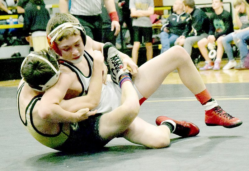PHOTO BY RICK PECK McDonald County&#8217;s Oscar Ortiz turns Lebanon&#8217;s Hunter Lewis to his back on the way to a 10-8 win in the 106 pound championship match at the Neosho Wrestling Tournament.
