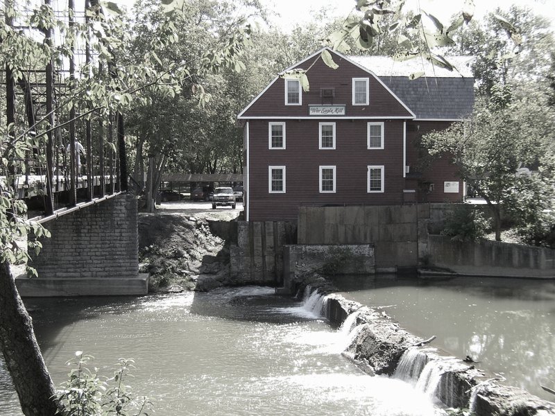 The fourth War Eagle Mill is a reproduction of the 1872 mill built by J.A.C. Blackburn. This mill — rebuilt in 1973 on the original foundation — still grinds grain today with water power from the War Eagle River.