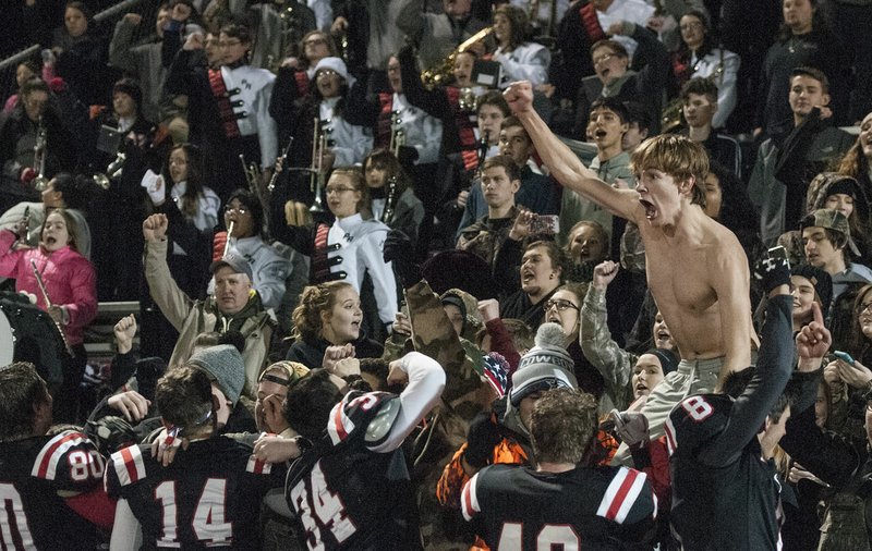 Pea Ridge High School students, fans and players cheer Friday at Blackhawks Stadium in Pea Ridge after defeating Shiloh Christian, 30-24. The win earned the Blackhawks a chance to win the state title Friday against Warren.