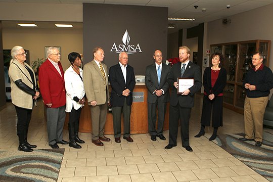 The Sentinel-Record/Richard Rasmussen CREATIVE GIFT: ASMSA Director Corey Alderdice, third from right, thanks the Oaklawn Foundation Tuesday during a grant presentation at the school. The foundation awarded the school a $300,000 grant for the construction of a new Creativity and Innovation Complex. Those present for the announcement, from left, included Charleen Copeland, chair of the Hot Springs Area Community Foundation and liaison to the Oaklawn Foundation; foundation members Larry Stephens, Helen Harris, Kermit Tucker and Dennis Smith; University of Arkansas System President Donald Bobbitt; Vicki Hinz, ASMSA director of institutional advancement; and Steve Faris, ASMSA Board of Visitors.