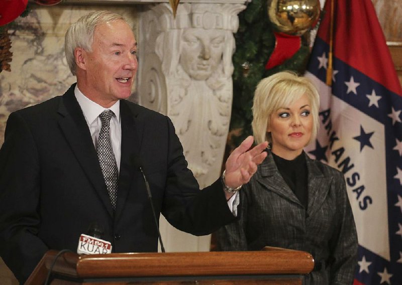 Gov. Asa Hutchinson, with Department of Higher Education Director Maria Markham, describes a new grant program Thursday for students at two-year colleges or technical schools.