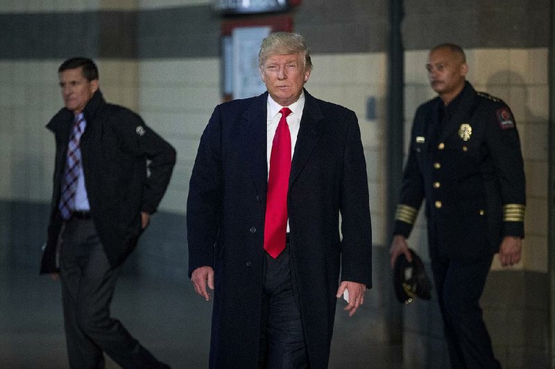 President-elect Donald Trump, with Michael Flynn, nominee for national security adviser (left), and Ohio State University Police Chief Craig Stone, arrives to speak with reporters Thursday after visiting with people affected by the recent knife attack at the Columbus campus.