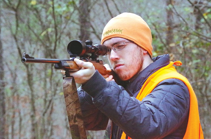 The gift of a new gun, as shown here with Zach Sutton of Alexander, would make any hunter ecstatic, but givers have many less-expensive options, too, everything from hunting clothing to accessories and camping gear.
