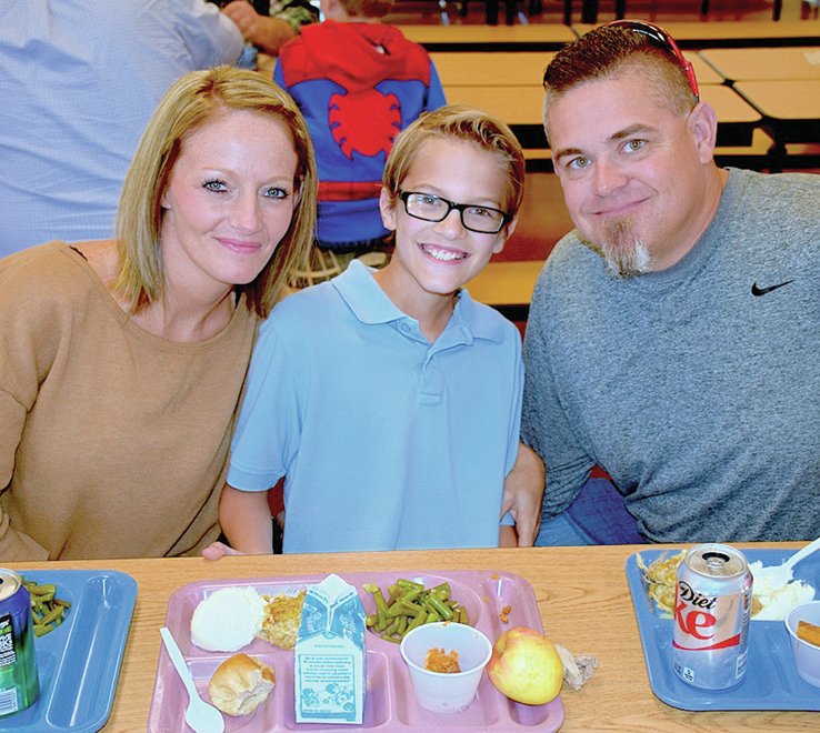Submitted photo Lake Hamilton Intermediate School student Noah Hoofman, center, welcomed his mother, Candice Hoofman, left, and his father, Brent Hoofman, for Family Turkey Day at the school. Students in Jana Catlettt's class invited their parents to join them for lunch and a classroom activity. Students read poems during their "Espresso Yourself" activity.