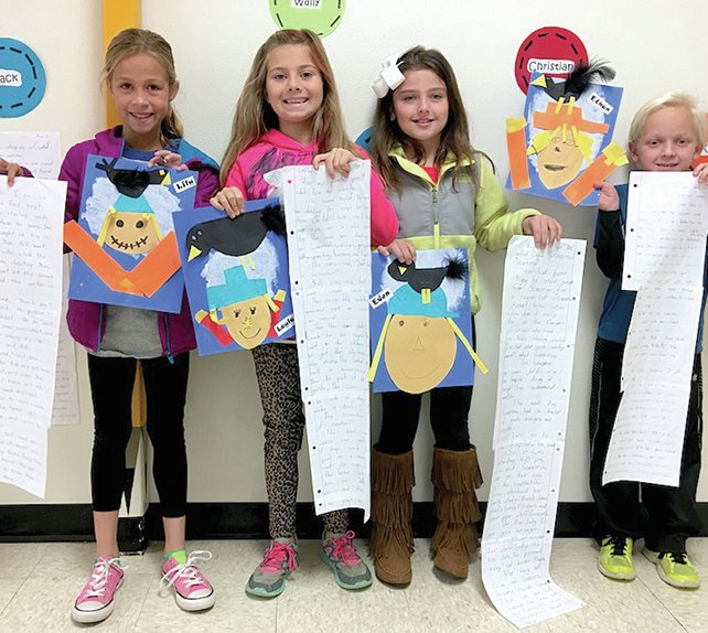 Submitted photo Third-grade students, from left, Eden Everson, Ethan Branson, Lily Ahlers and Layla Lewis write a narrative in Erin Miller's class at Lakeside Intermediate School about a scarecrow and a crow becoming friends.