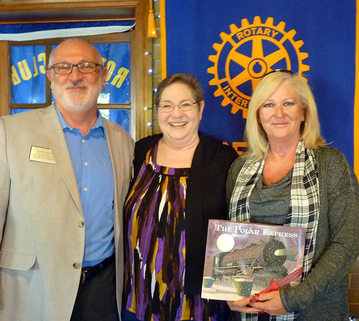 Submitted photo A working meeting was held by members of the Rotary Club of North Garland County/ Scenic 7 on Dec. 1. Michael Dollar, left, the executive director of the Hot Springs Village Area Chamber of Commerce, joined Scenic 7 President Diane Upchurch and Diane Jester, chairperson of the chamber board, for lunch. The two led a discussion for Rotarians, and sought input on ways to improve the appeal and traffic for businesses along the Highway 7 north corridor. Many club members participated in the brainstorming session. Jester holds a book to be donated to a local school in honor of these guest speakers. Scenic 7 Rotary meets at noon on Thursdays in Charlie's Pizza Pub, 127 McNeely Circle, and visitors are always welcome. Call Jan Saunders at 501-282-2024 for more information.