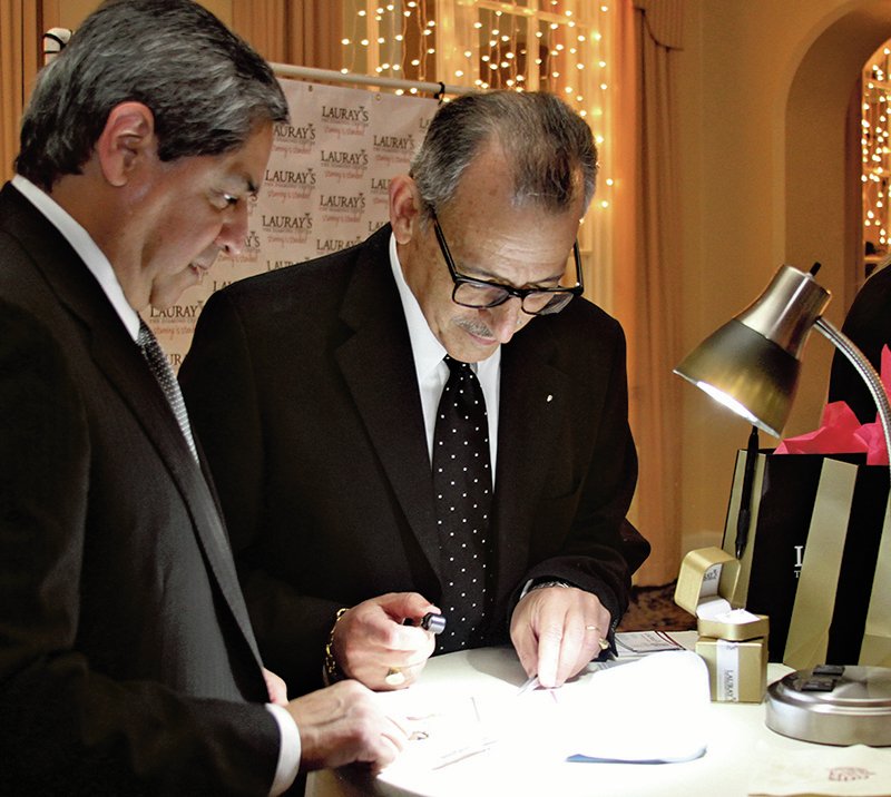 The Sentinel-Record/Mara Kuhn Mark Fleischner, owner of Lauray's The Diamond Center, right, and Art Amaro, store manager, examine a diamond during Ice on Ice, the holiday season's premiere event, held Thursday night at the Arlington Resort Hotel & Spa. Those in attendance had the opportunity to win one of four half-carat diamonds while enjoying appetizers, entertainment and the signature drink of the evening. Proceeds from the event, sponsored by the Greater Hot Springs Chamber of Commerce, Lauray's, the Arlington and 105.9 KLAZ, will go to benefit the Project HOPE Foodbank.