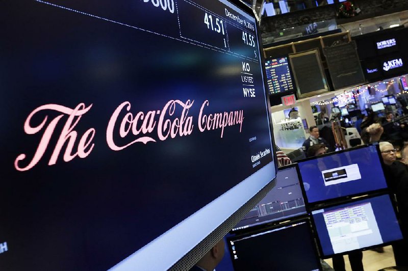 The Coca-Cola logo is on display Friday above where the company’s shares trade on the floor of the New York Stock Exchange. The stock closed up 2.5 percent Friday.