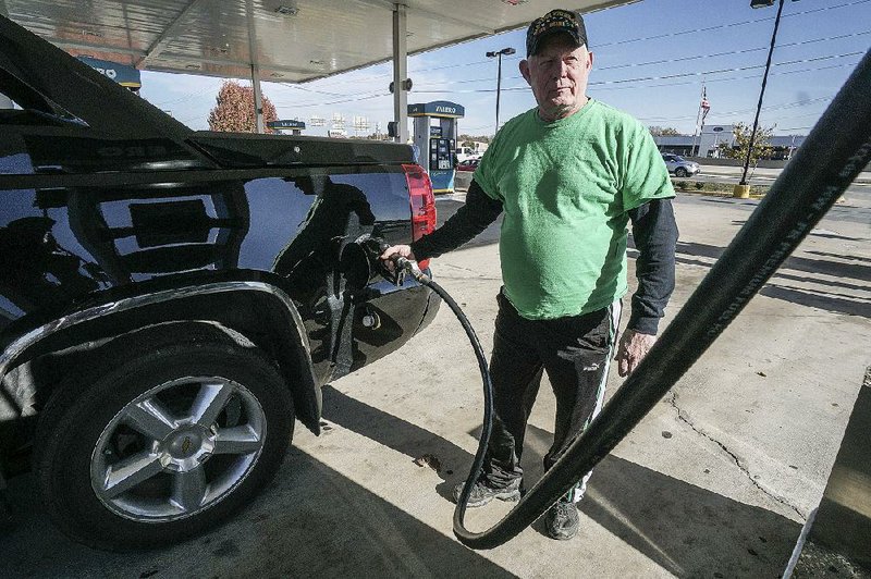 Micheal Campbell pumps gas into his car Friday at the Valero station on Warden Road in North Little Rock. Gas prices are expected to stay where they are for the rest of the year.
