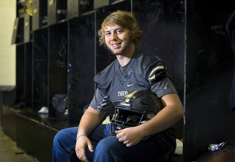 Charleston middle linebacker Garrett Loughridge sits in the locker room Wednesday at Charleston High School.