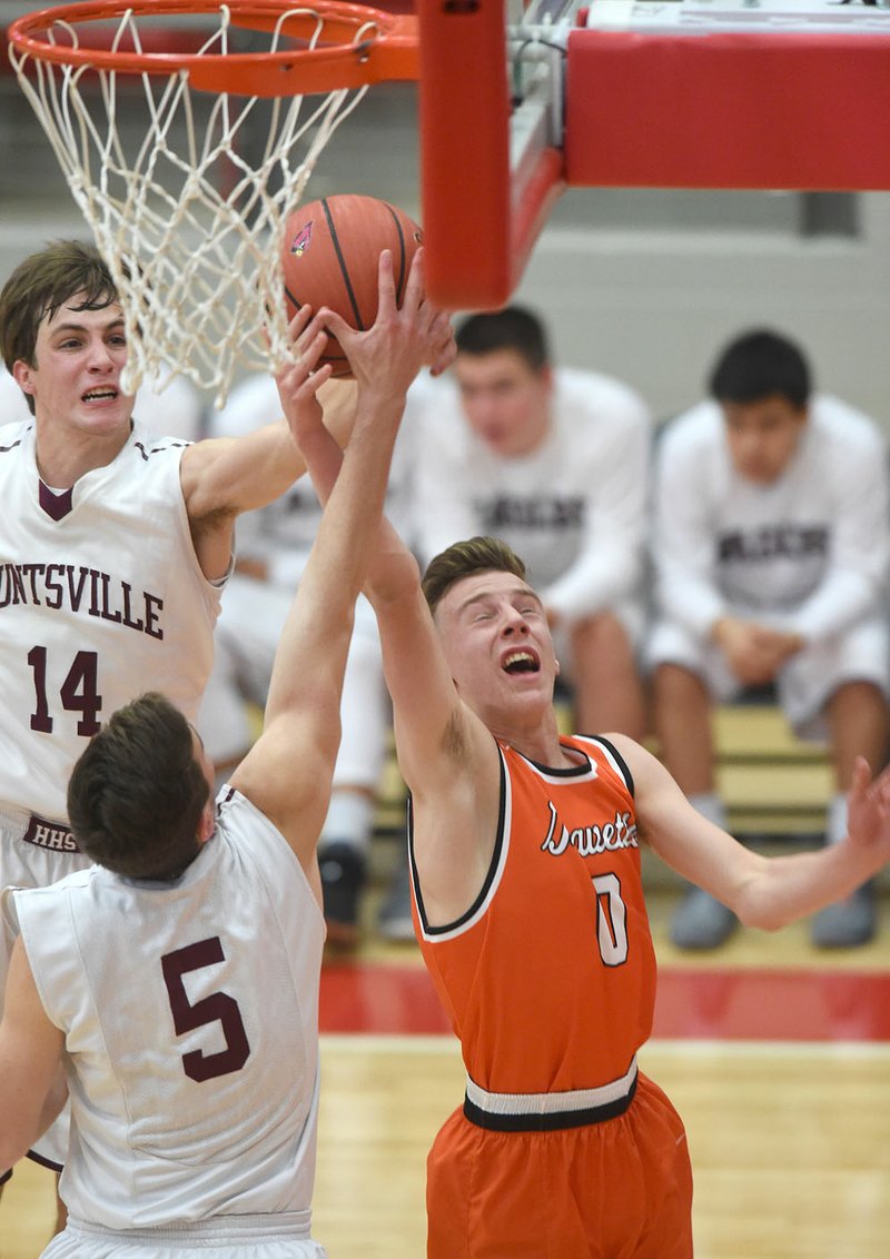 Gravette’s Seth Duke (0) has his shot blocked by Huntsville defenders Jack Eaton (14) and Clay Siegrist (5) as he drives to the hoop Friday during the Tony Chachere Classic in Farmington.