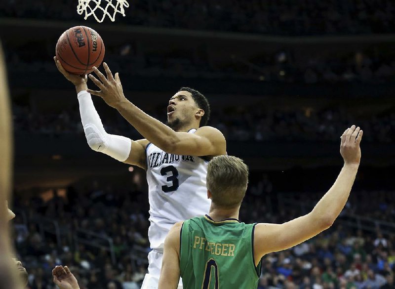 Villanova guard Josh Hart (left) goes up for a layup over Notre Dame defender Rex Pflueger in Saturday’s game. Hart scored a career-high 37 points and grabbed 11 rebounds to pace the top-ranked Wildcats to a 74-66 victory over the No. 23 Fighting Irish.