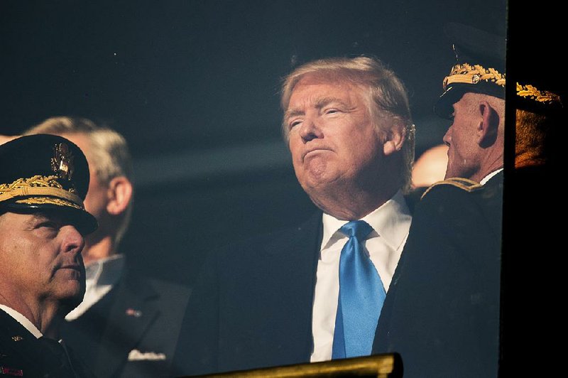 President-elect Donald Trump listens to a member of the military in the stands as he watches Saturday’s Army-Navy college football game at M&T Bank Stadium in Baltimore.