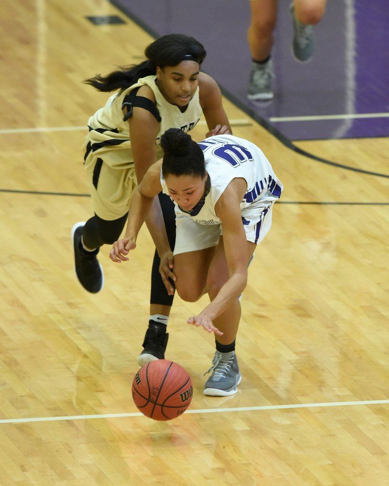 Fayetteville’s Natalie Rimmer (left) steals the ball from Little Rock Central’s Bre’ Amber Scott as she scores a layup in the final minute Saturday during their game in the Lady Bulldog Classic at Fayetteville High School.