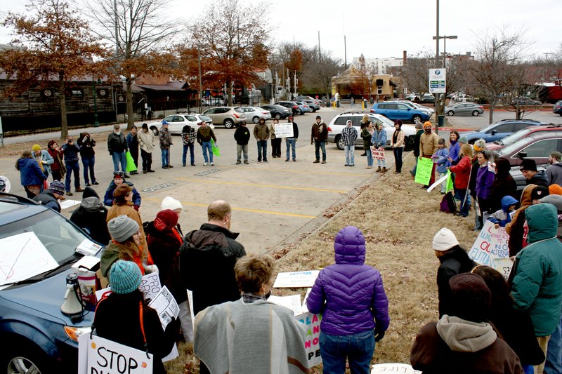 Protesters against the Diamond Pipeline gather Saturday in a prayer circle before marching on Dickson Street in Fayetteville. The Diamond Pipeline is a 440-mile pipeline under construction to carry crude oil from Cushing, Okla., to Memphis, Tenn. The pipeline will cross 14 counties in north-central Arkansas.