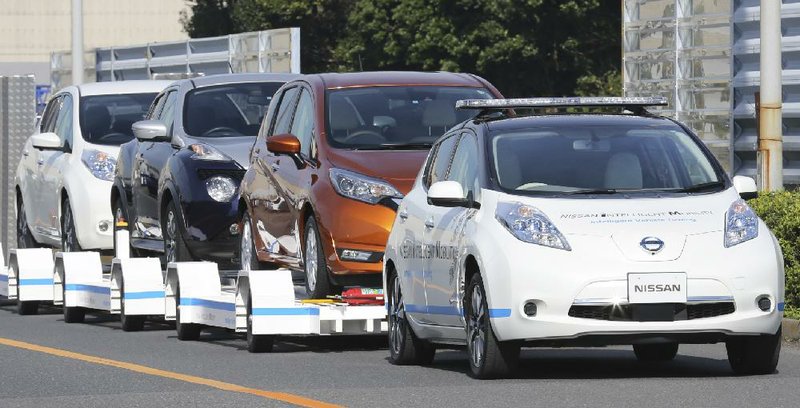 A self-driving version of Nissan Motor Co.’s Leaf pulls a trailer carrying three other Leafs during a demonstration of the automaker’s Intelligent Vehicle Towing system at Nissan Oppama plant in Yokohama, near Tokyo, last week.