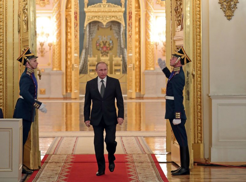 Russian President Vladimir Putin enters a hall to attend a reception marking Heroes of the Fatherland Day in the Kremlin in Moscow, Russia, Friday, Dec. 9, 2016. 