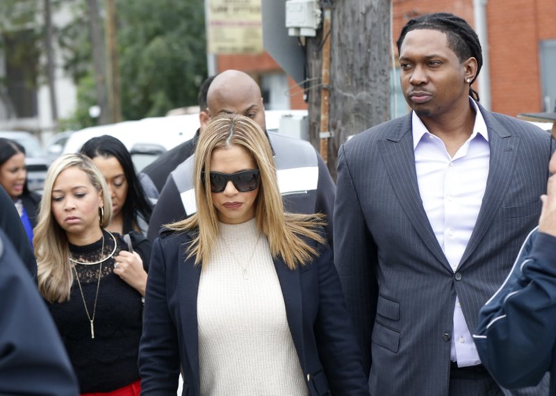 In this Dec. 7, 2016, file photo, Racquel Smith, widow of former NFL New Orleans Saints football player Will Smith, arrives with family and friends at Orleans Parish Criminal District Court, for the trial of Cardell Hayes in New Orleans. Hayes was convicted of manslaughter Sunday, Dec. 11, in the fatal shooting of Will Smith. 
