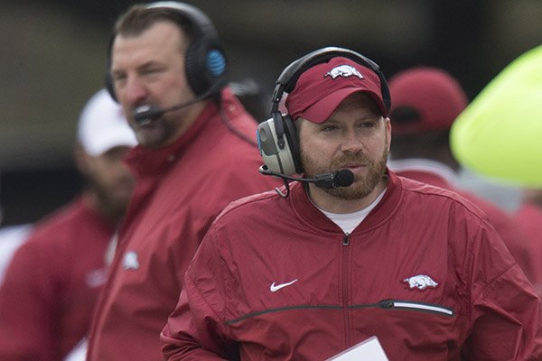 Arkansas defensive coordinator Robb Smith, foreground, walks the sideline as head coach Bret Bielema, background, watches during a game against Missouri on Friday, Nov. 25, 2016, in Columbia, Mo. 