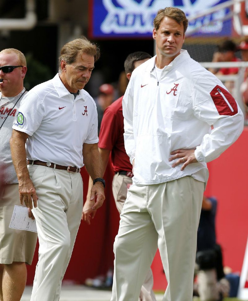 Alabama Coach Nick Saban (left) will have offensive coordinator Lane Kiffin on his staff for at least one more game before Kiffin heads to Florida Atlantic to take over an Owls program that’s won just nine games total over the past three seasons.