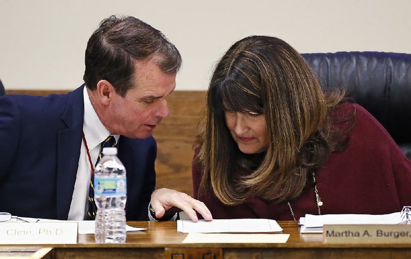 Terry Cline (left), Oklahoma commissioner of health, and Martha Burger, president of the Oklahoma Board of Health, confer Tuesday in Oklahoma City on a state abortion-reduction plan to post signs in public restrooms to direct pregnant women where to get services.