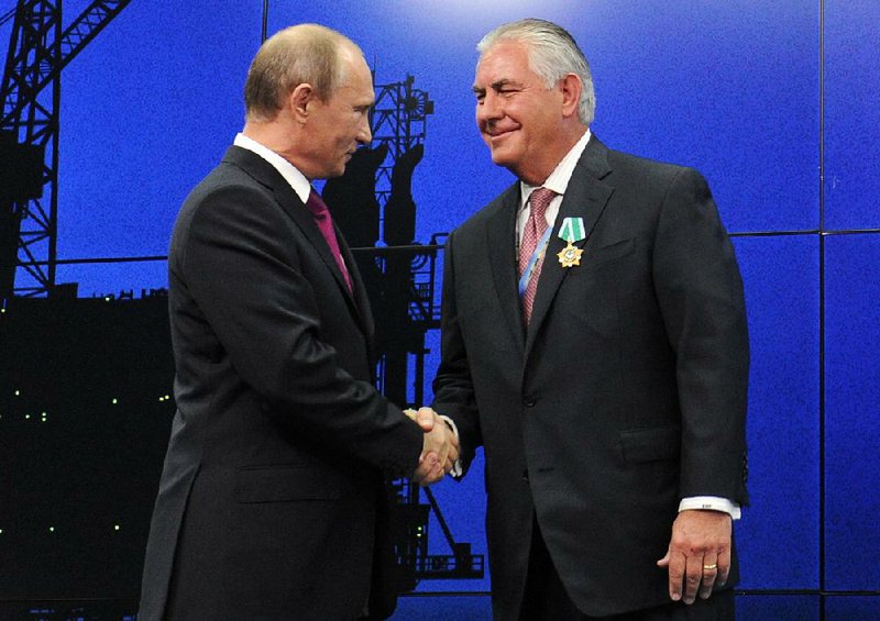 Russian President Vladimir Putin presents a medal to Rex Tillerson at an award ceremony in June 2012 at an economic forum in St. Petersburg, Russia.