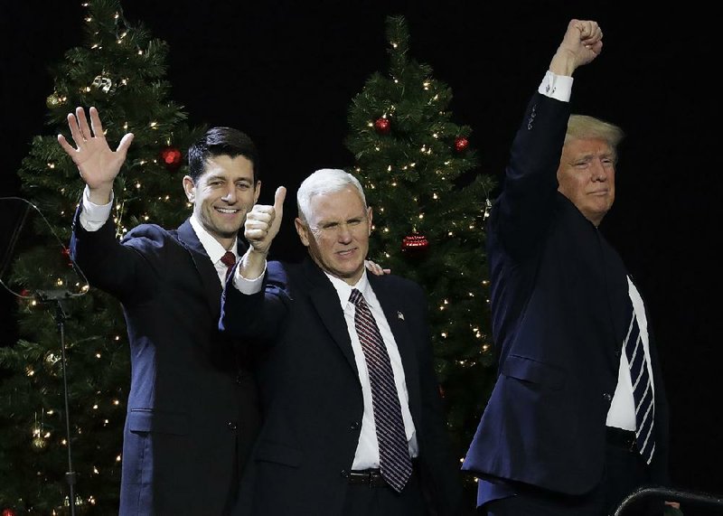 House Speaker Paul Ryan (left) and Vice President-elect Mike Pence join President-elect Donald Trump at a rally Tuesday in West Allis, Wis. Ryan was greeted with some boos, but Trump defended him.