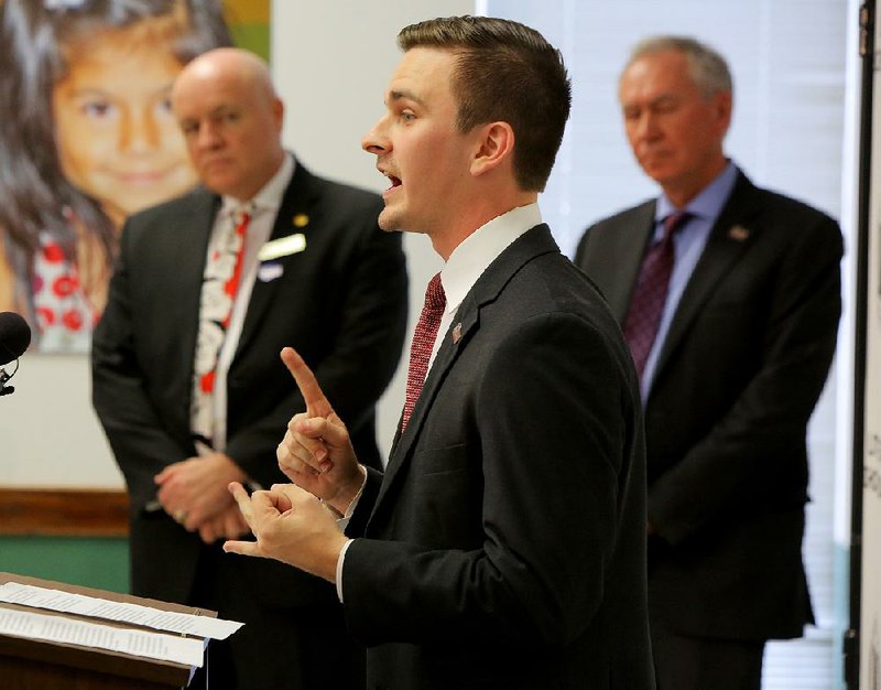 Connor Donovan, a University of Arkansas at Little Rock Donaghey Scholars Program student, speaks Tuesday about a partnership between UALR and Little Rock School District high schools. Little Rock schools Superintendent Mike Poore (left) and UALR Chancellor Andrew Rogerson (right) listen in.