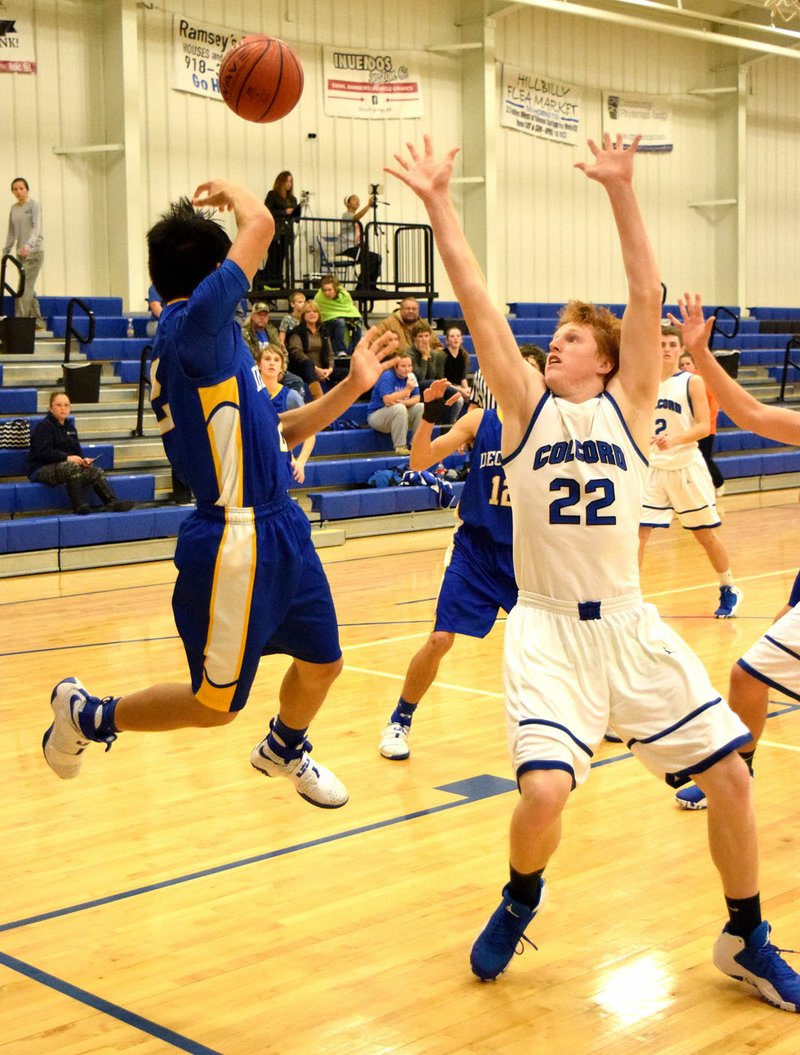 Photo by Mike Eckels Decatur&#8217;s Leng Lee (2), tries to drive toward the basket and finds his path blocked by several Colcord defenders. He makes a quick decision to pass to Bracy Owens (12) who was open on the wing. The Bulldogs took the victory from the Colcord Hornets during the opening round of the Colcord Hoopfest 2016 in Hornet Arena Dec. 8.