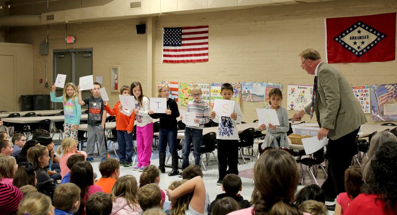 Photo by Zane Vanderpool Richard Page, superintendent of Gravette Public Schools (right), gave a brief lesson about courtesy at the Glenn Duffy Elementary Rise and Shine assembly last week. He involved several GDE students, shown here, to help him show how courtesy can be shown at home, on school buses, in classrooms and in hallways.