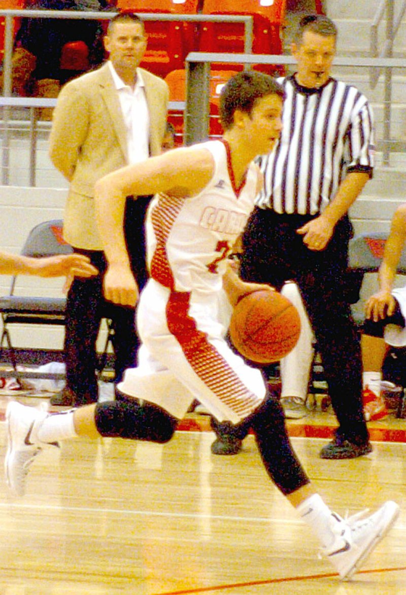 Man on the move. Farmington senior Matt Wilson pushes the ball up the floor with a left-handed dribble as Cardinal coach Beau Thompson looks on during the Tony Chachere&#8217;s Classic held last week at Cardinal Arena. Wilson scored 27 in Saturday&#8217;s championship won by Farmington, 60-45, over Huntsville.