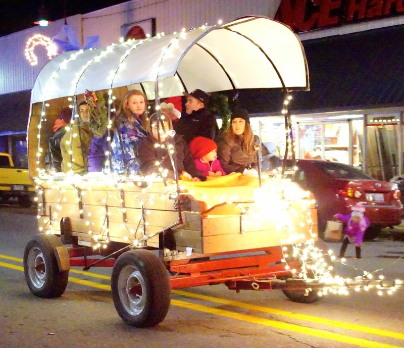 Photo by Randy Moll This well-lit covered wagon was a part of the annual Gentry Chamber of Commerce Christmas Parade on Saturday.