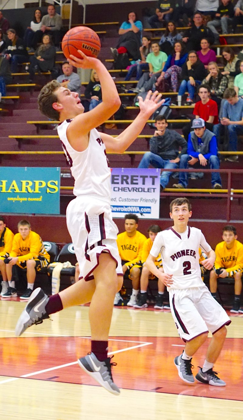 With Ethan Hammond in the background, Logan Linton makes an easy jump shot during play against Prairie Grove at Gentry on Friday, Dec. 9.