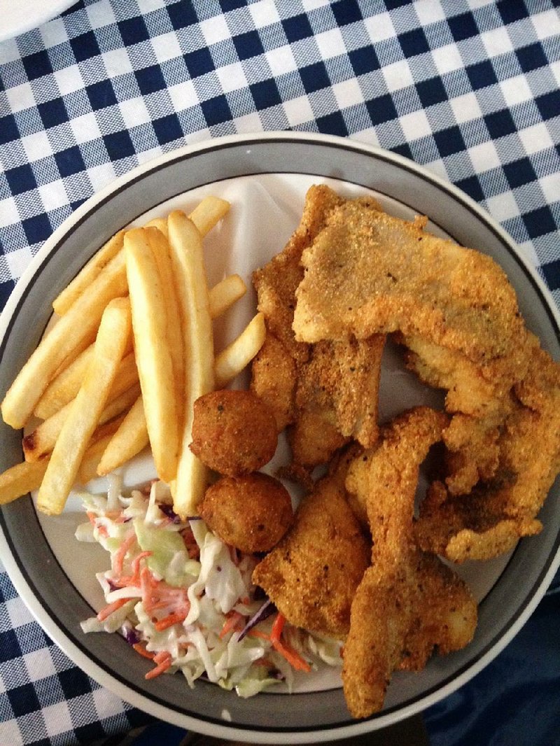 Catfish fillets are served with hush puppies, slaw and fries at the Lassis Inn in Little Rock. sean cl

